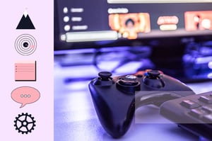An Xbox controller on a desk with a gaming monitor out of focus in the background