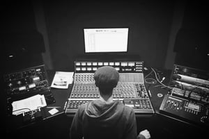A photo of dBs tutor Jacopo Chiari operating the API 1608 mixing desk at dBs Bristol