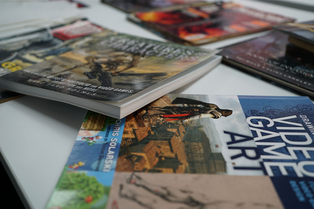 A pile of books and comics on game art