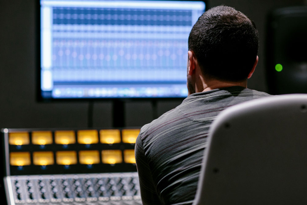 A student working on the API 1608 mixing console