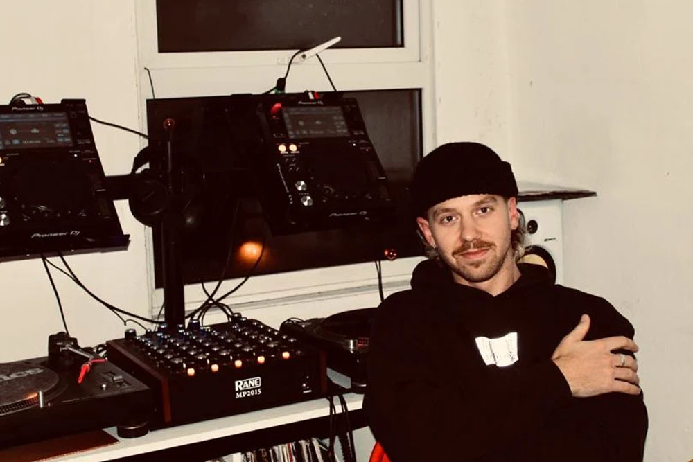 Adam Berwick in front of a DJ setup