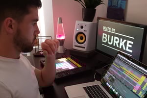 Aidan sat at his laptop in his home studio