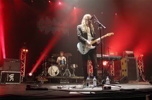 A picture of Haunt the Woods' guitarist and drummer performing their headline show at Plymouth Pavilions