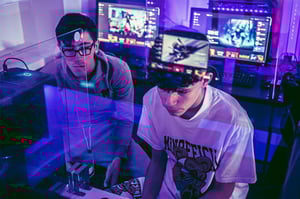 Two young people playing an online multiplayer game 