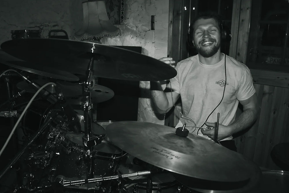 B&W photo of Olly Bignell playing drums