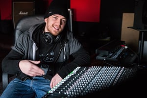 Jus Mike sat behind the mixing console in his mobile recording studio
