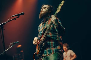 Jack Hale performing bass on stage with Plymouth band Haunt the Woods