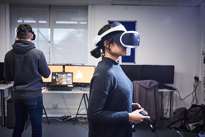 Two students using the Playstation VR headset