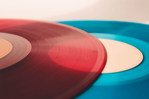Two coloured vinyl records overlaid on top of one another