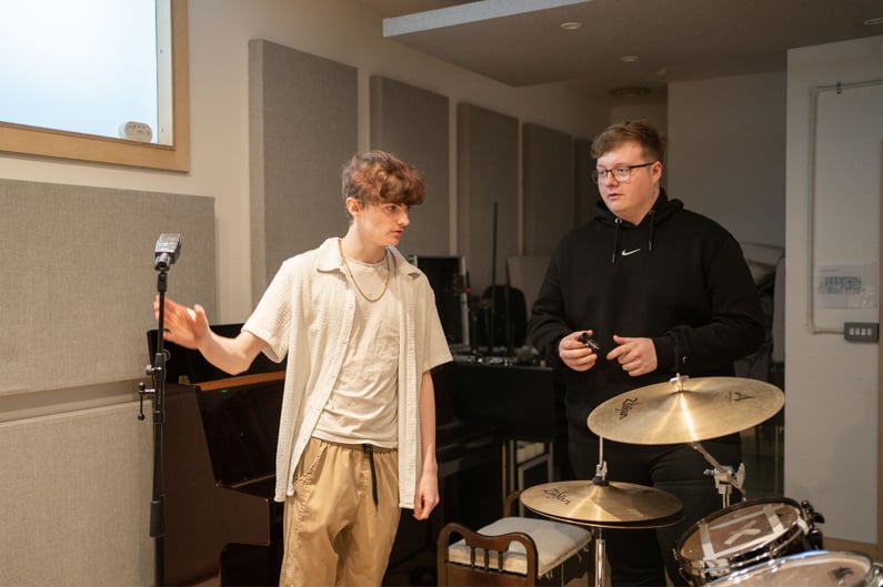 Music manager with artist in studio