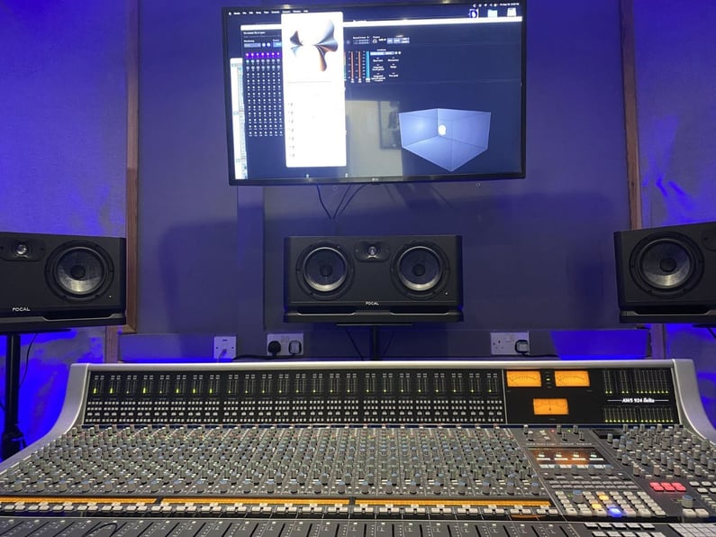 Music production studio with a mixing console