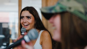 Two students singing with microphones