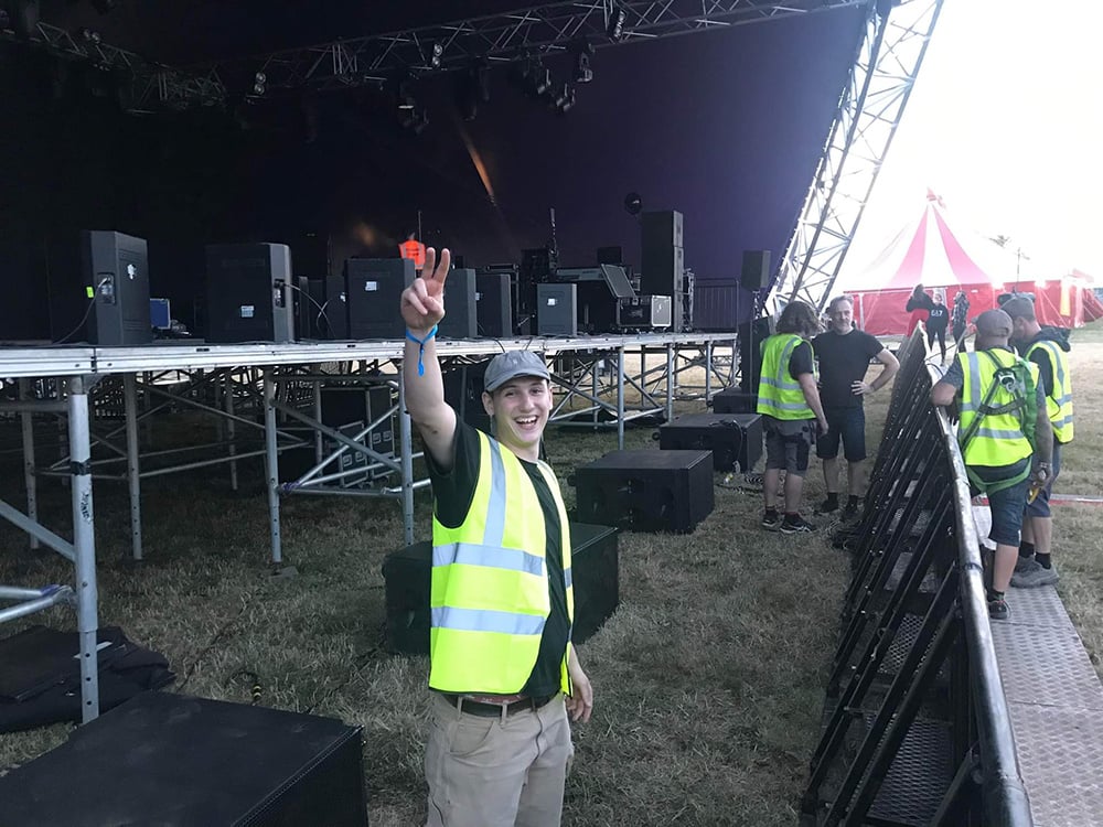 Student working on a stage at a festival