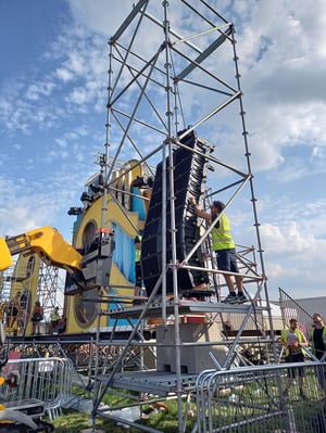 Students setting up a line array at a festival