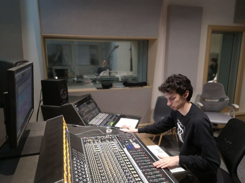 Studio Engineer at work on mixing console