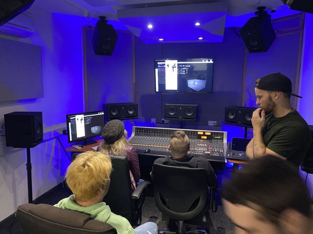 Studio engineers inside Music Production studio together