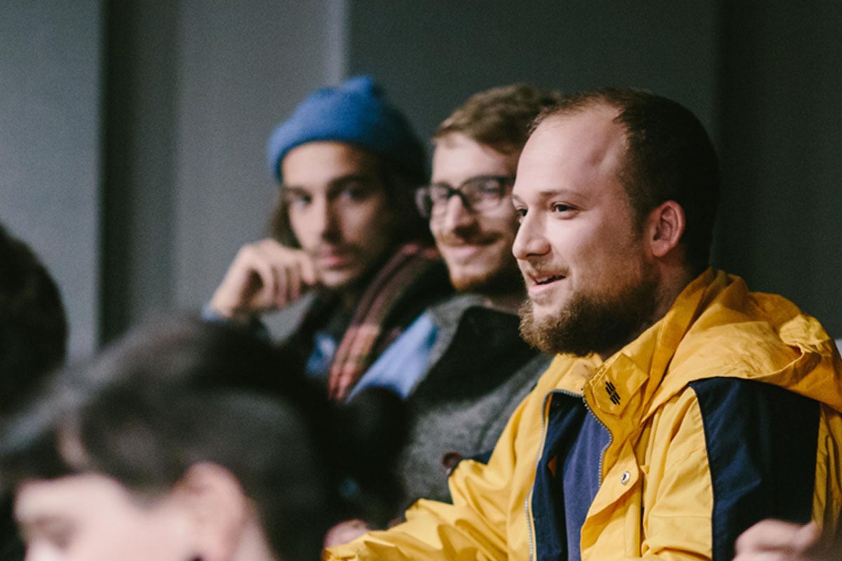 Three students attending a seminar in the dBs Bristol lecture theatre