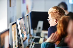 Students working on projects using iMac computers